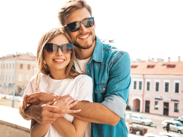 Portrait of smiling beautiful girl and her handsome boyfriend. Woman in casual summer jeans clothes.    