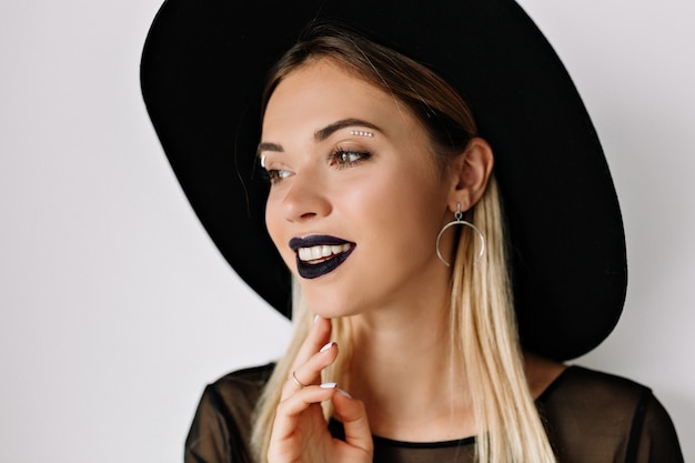 Free photo portrait of smiling charming woman with black lipstick and black hat