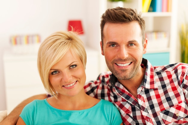 Portrait of smiling couple in living room