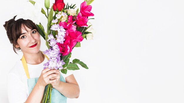 Portrait of a smiling female florist with bunch of flowers