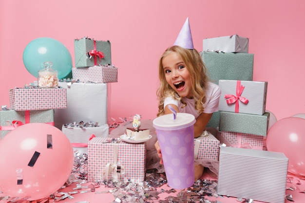 Portrait of a smiling girl in a birthday hat celebrating