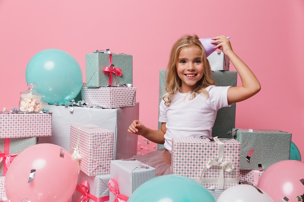 Portrait of a smiling girl in a birthday hat celebrating