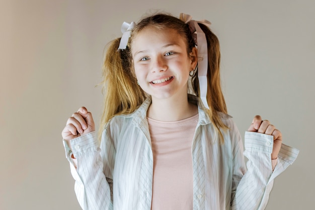 Free Photo portrait of a smiling girl on colored background