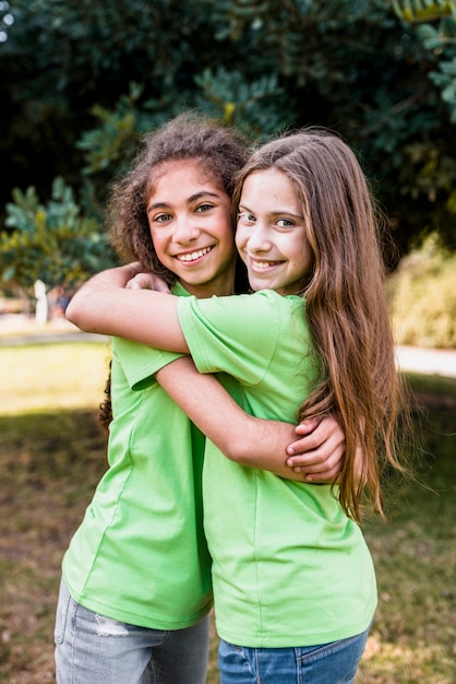 Free photo portrait of a smiling girl embracing each other