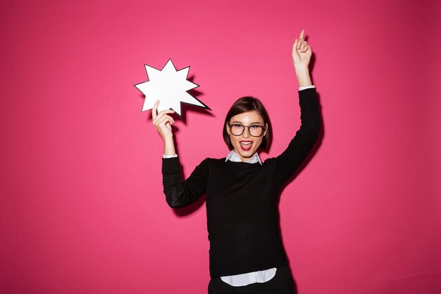 Portrait of a smiling happy businesswoman with exclamation speech bubble