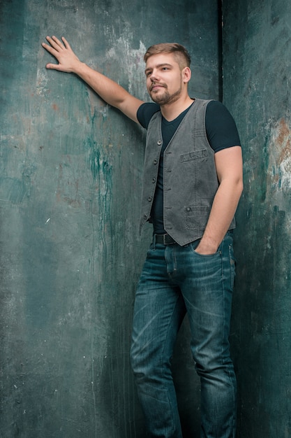 Portrait of smiling happy man standing in studio