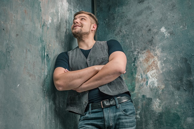 Portrait of smiling happy man standing in studio