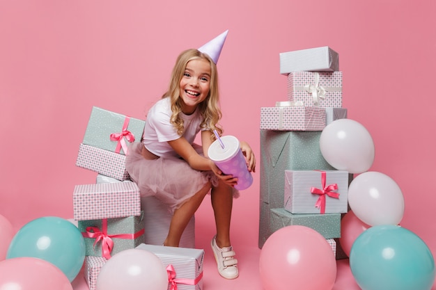 Portrait of a smiling little girl in a birthday hat