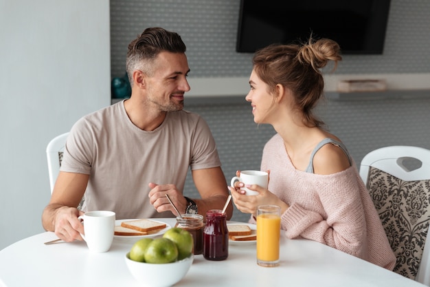 Portrait of a smiling loving couple having breakfast