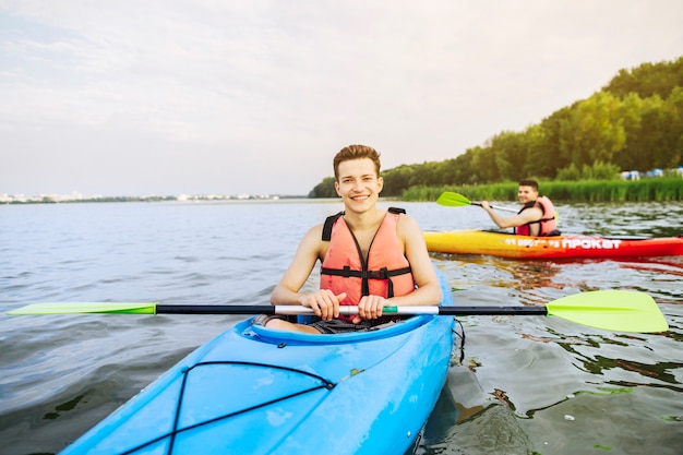 Free Photo portrait of smiling male kayaker kayaking on lake