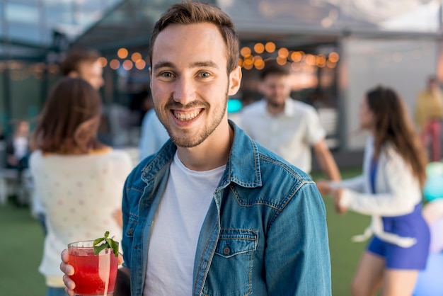 Free Photo portrait of a smiling man at a party