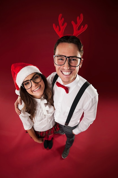 Free photo portrait of smiling nerd couple in christmas time