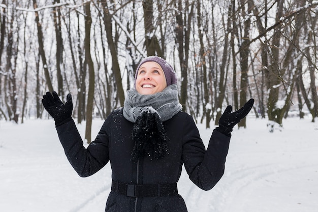 Portrait of a smiling pretty woman having fun at winter season