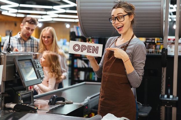 Free Photo portrait of smiling woman cashier