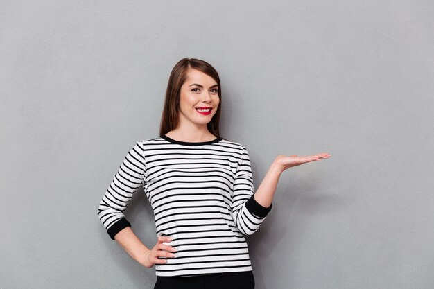 Portrait of a smiling woman holding copy space