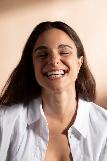 Portrait of smiling woman posing in a white shirt