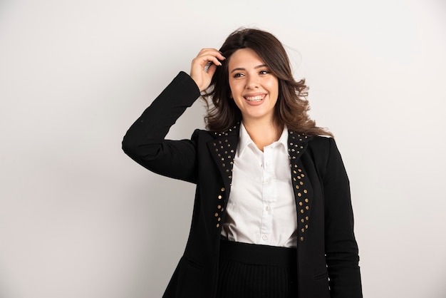 Portrait of smiling woman posing on white.