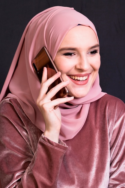 Portrait of smiling woman talking on mobile phone