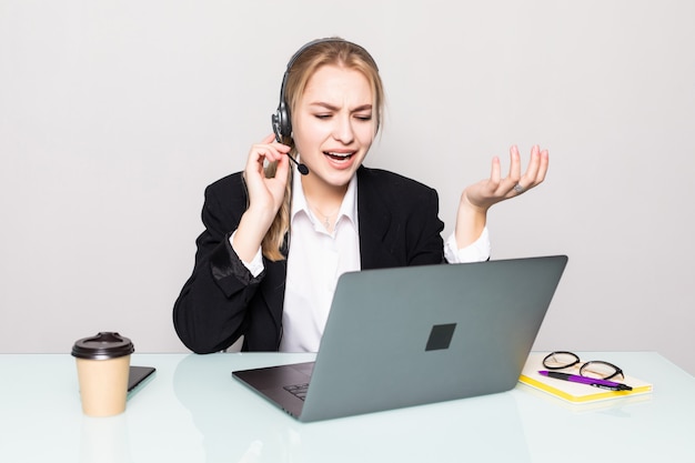 Free photo portrait of smiling woman with laptop helpline operator with headphones at office