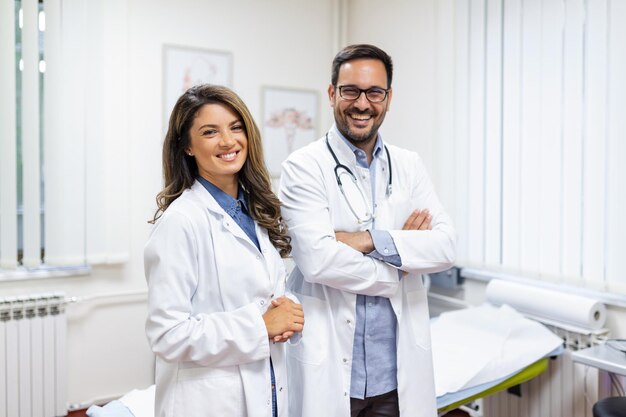 Portrait of smiling young doctors standing together Portrait Of Medical Staff Inside Modern Hospital Smiling To Camera