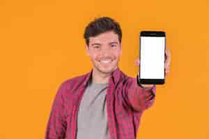 Free photo portrait of a smiling young man showing blank white screen mobile phone