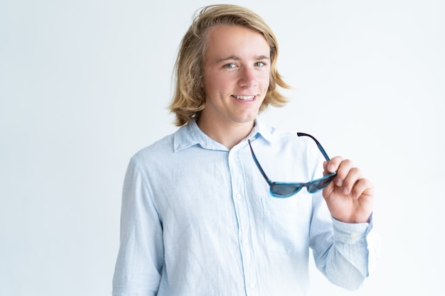 Free Photo portrait of smiling young student holding eyeglasses