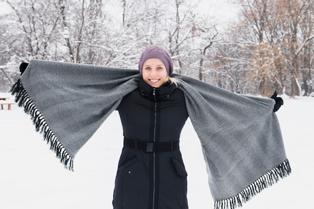 Free Photo portrait of a smiling young woman holding scarf looking at camera