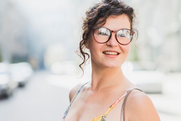 Portrait of a smiling young woman with eyeglasses