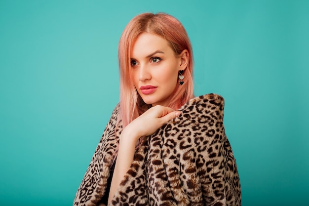 Free Photo portrait of stunning woman with pink hair in stylish winter fluffy coat with leopard print