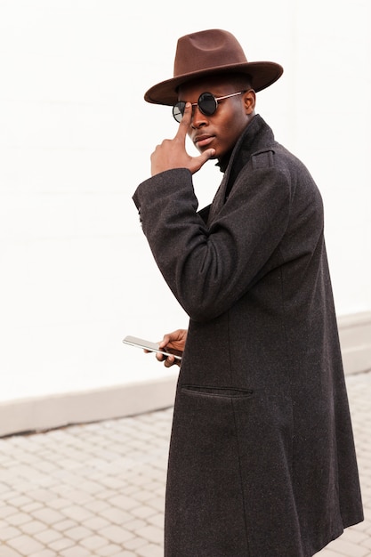 Portrait of stylish adult male posing with sunglasses