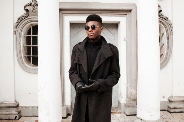 Portrait of stylish adult male posing with sunglasses