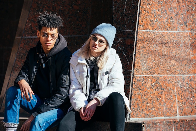 Portrait of stylish interracial young couple looking at camera