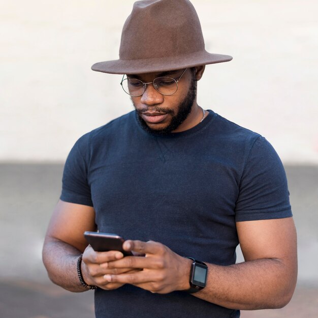 Portrait of stylish man looking on his phone