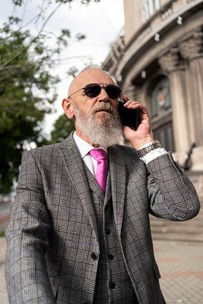 Portrait of stylish senior man speaking on the phone