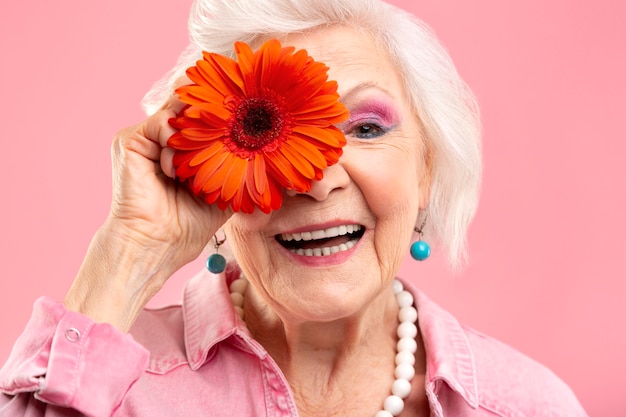 Portrait of stylish senior woman in pink