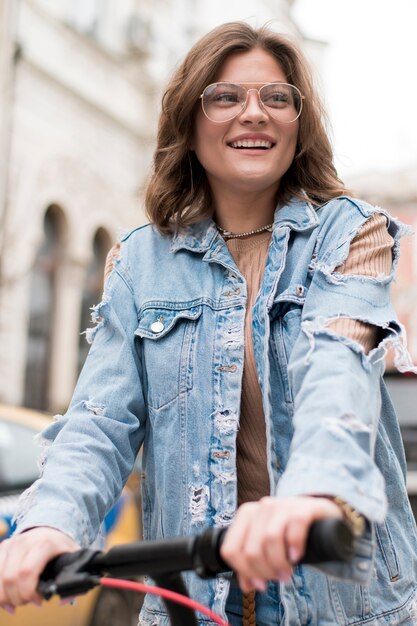 Portrait of stylish teenager riding electric scooter