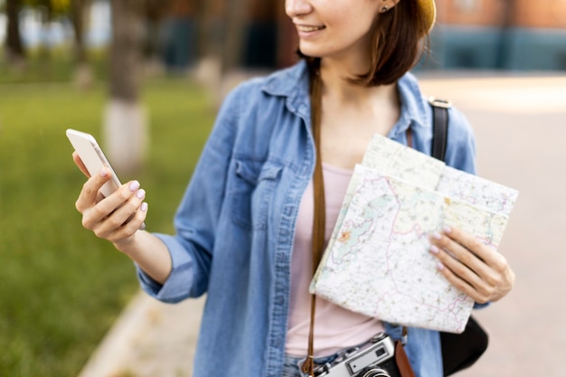 Free Photo portrait of stylish tourist checking mobile phone