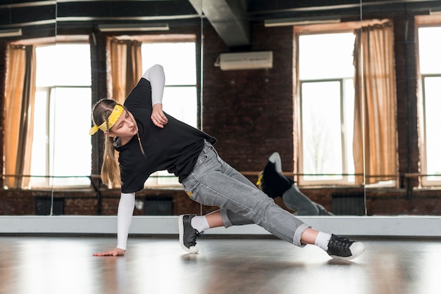 Portrait of a stylish young woman practicing dance in the studio