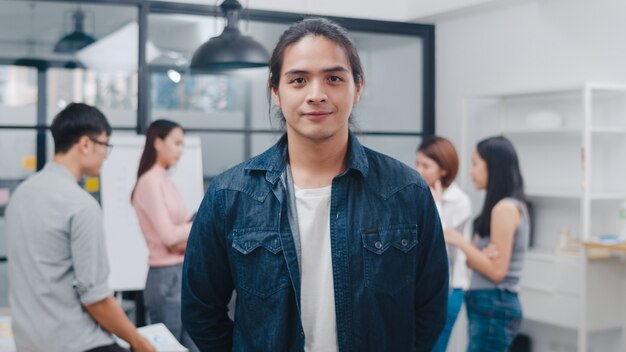 Portrait of successful handsome executive businessman smart casual wear looking at camera and smiling