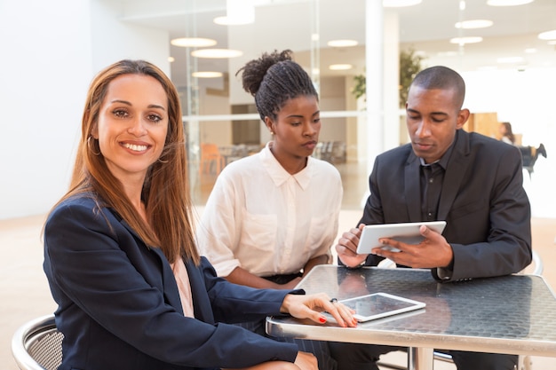 Free Photo portrait of successful young businesswoman with colleagues