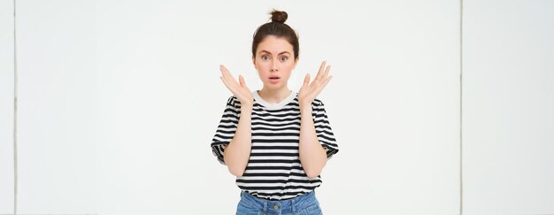 Portrait of surprised woman gasping looking amazed hear great news drops jaw says wow impressed by