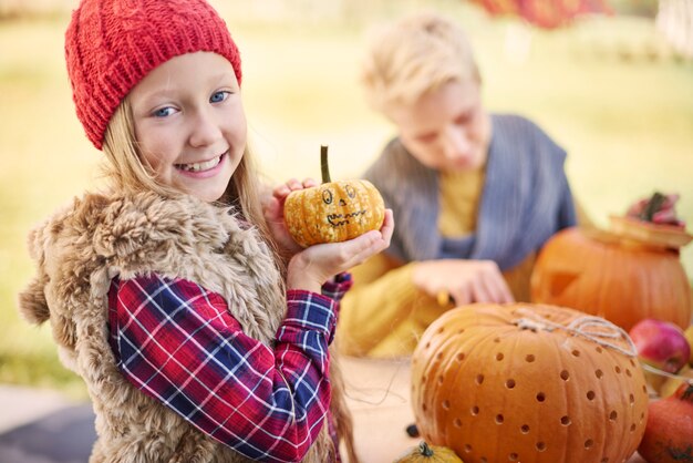 Portrait of sweet little girl with pumpkin