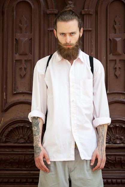 Free Photo portrait of tattooed hipster with long beard. style and diversity