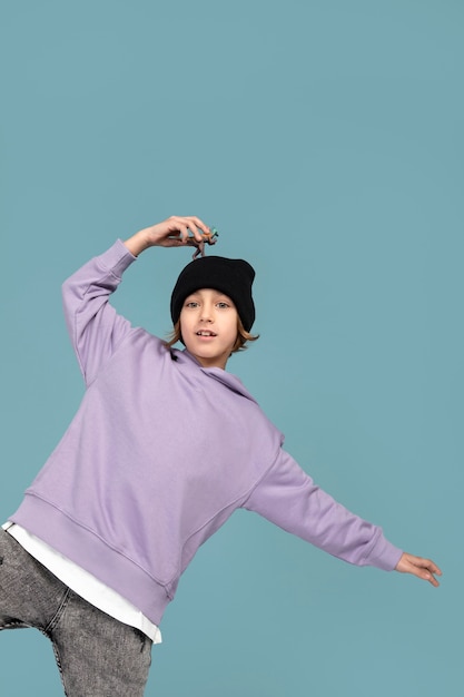 Portrait of teen boy keeping a dinosaur on his head