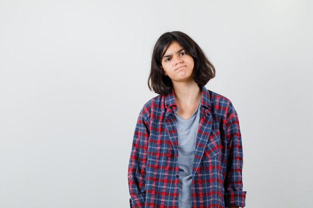 Portrait of teen girl in casual clothes and looking dismal front view