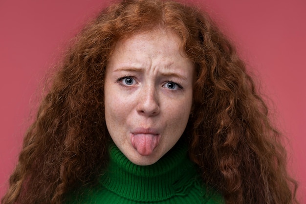 Portrait of teenage girl sticking her tongue out