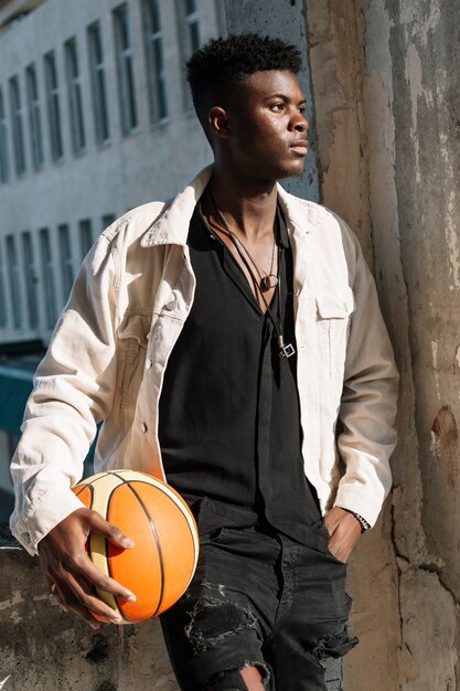 Portrait of teenager posing with basketball ball