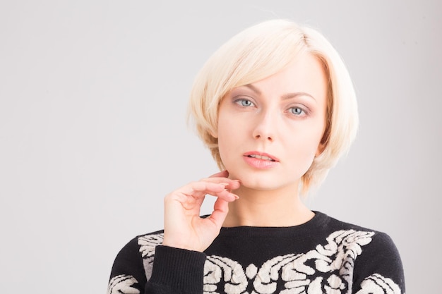 Free photo portrait of tender blond lady with delicate and clear skin posing for cosmetics magazine in studio.