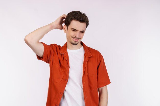 Portrait of thinking man surrounded by question mark on isolated background