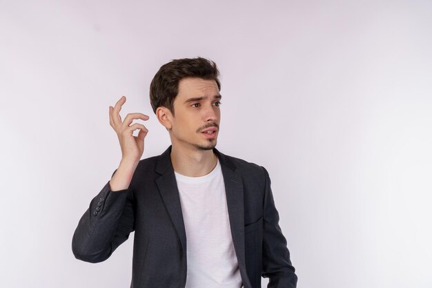 Portrait of thinking man surrounded by question mark on isolated background